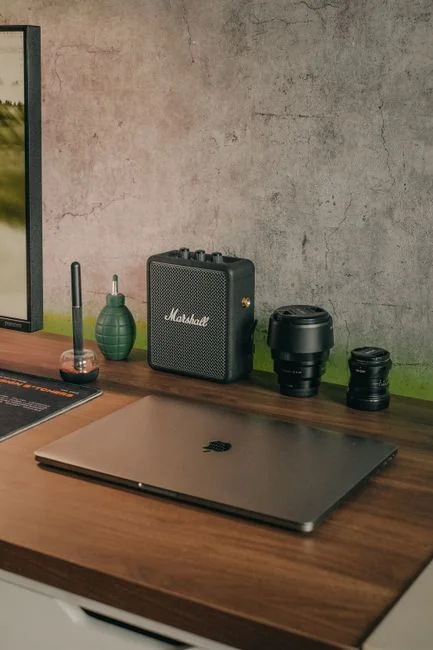 A woman wearing headphones leads an online webinar from her home office.